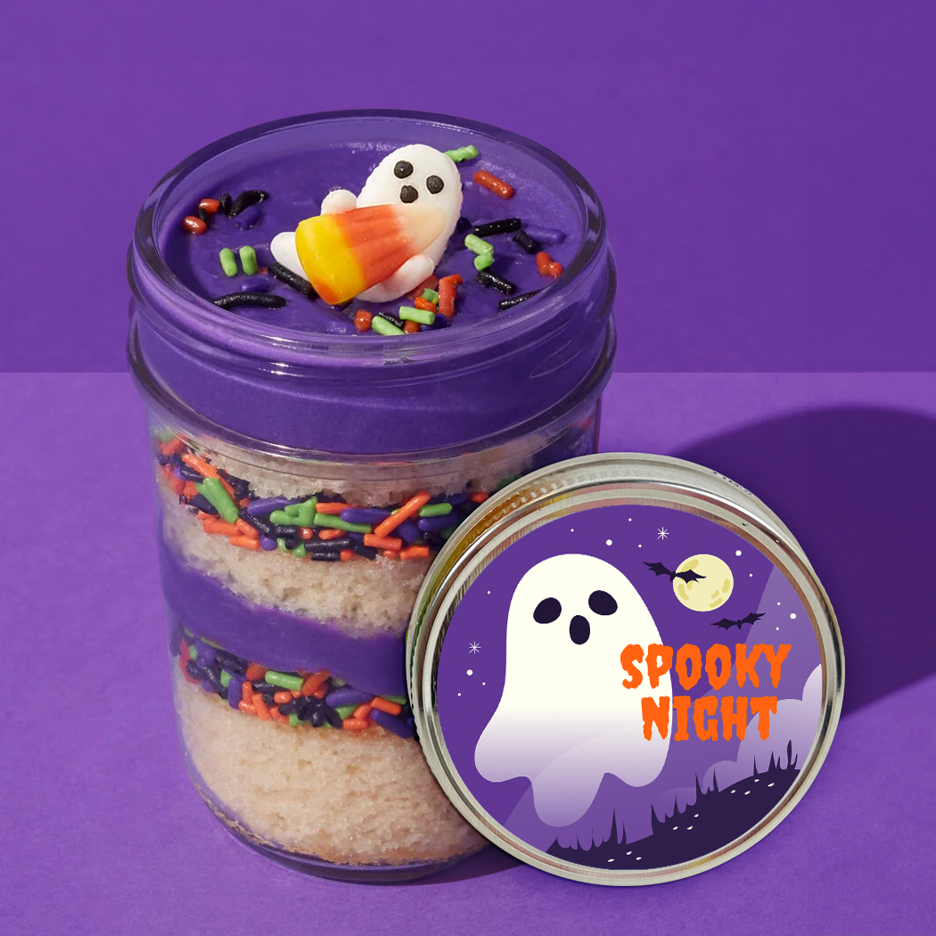 Lid label detail on a Halloween ghost kosher cupcake jar with purple frosting and ghost toppers.