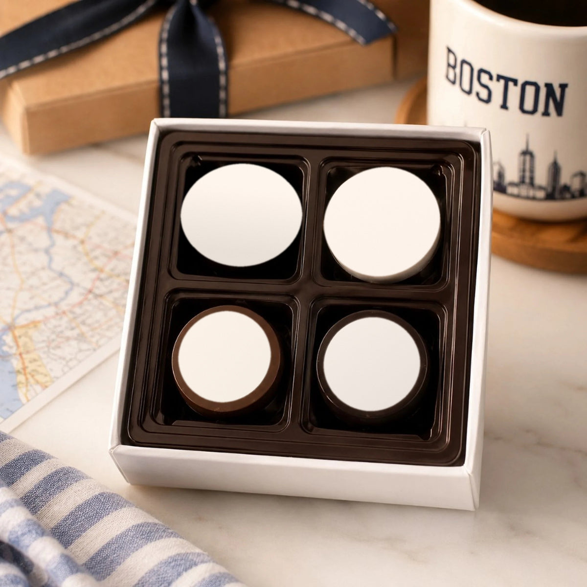 Four chocolate dipped Oreos with blank white logo discs in a white gift box, ready for a custom logo