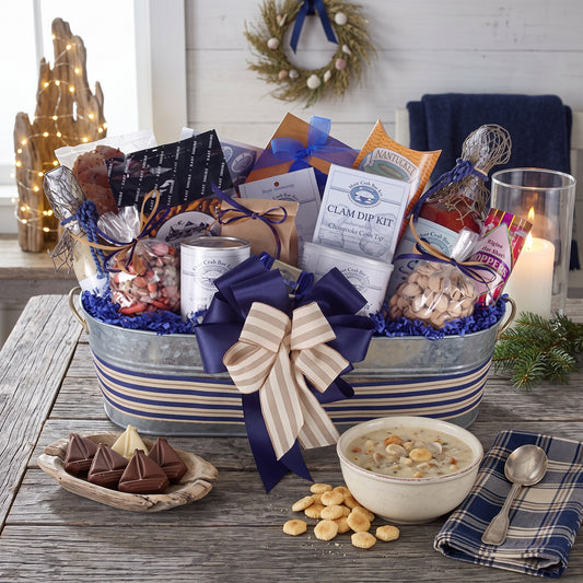 Holiday by the sea gift basket in a navy striped galvanized tub with clam chowder, Harbor Sweets and gourmet crackers, on a rustic table in a coastal cabin at Christmas
