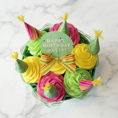 Top view of a birthday hat cupcake bouquet with paper party hats and a personalized Happy Birthday topper, kosher, made in Chestnut Hill MA