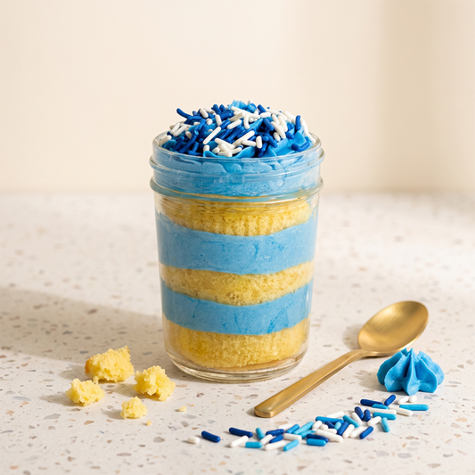 Blue bliss kosher cupcake jar with vanilla cake, blue vanilla frosting, and blue and white sprinkles.
