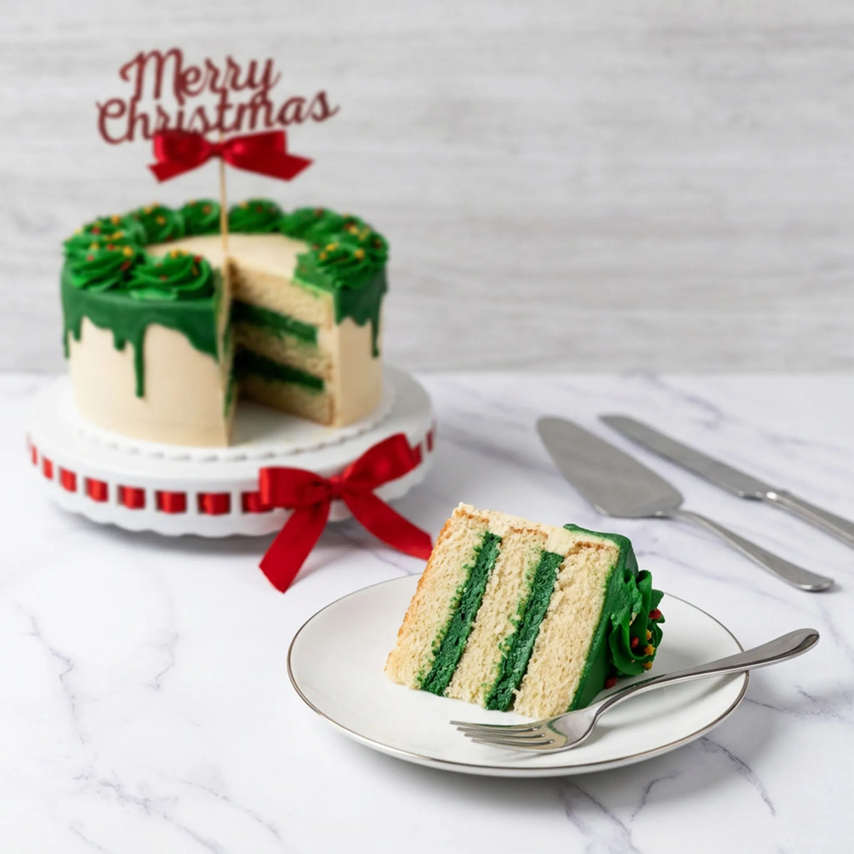 Sliced Christmas Wreath Cake showing green buttercream between vanilla layers, with a slice on a plate, kosher, made in Chestnut Hill MA