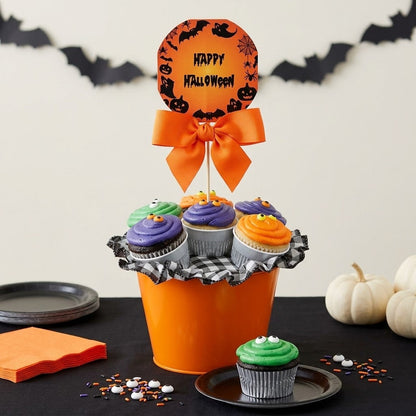 Halloween cupcakes in green, purple and orange buttercream with candy eyes in an orange pail with a Happy Halloween topper, kosher, made in Chestnut Hill MA