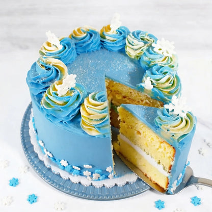Sliced Snowflake Cake showing vanilla layers with white filling under blue buttercream, rosettes and fondant snowflakes, kosher, made in Chestnut Hill MA