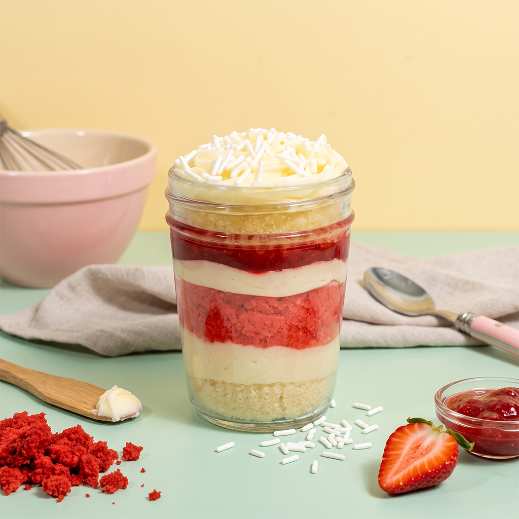 Strawberry kosher cupcake jar with lemon and strawberry cake, strawberry jam, and vanilla buttercream.