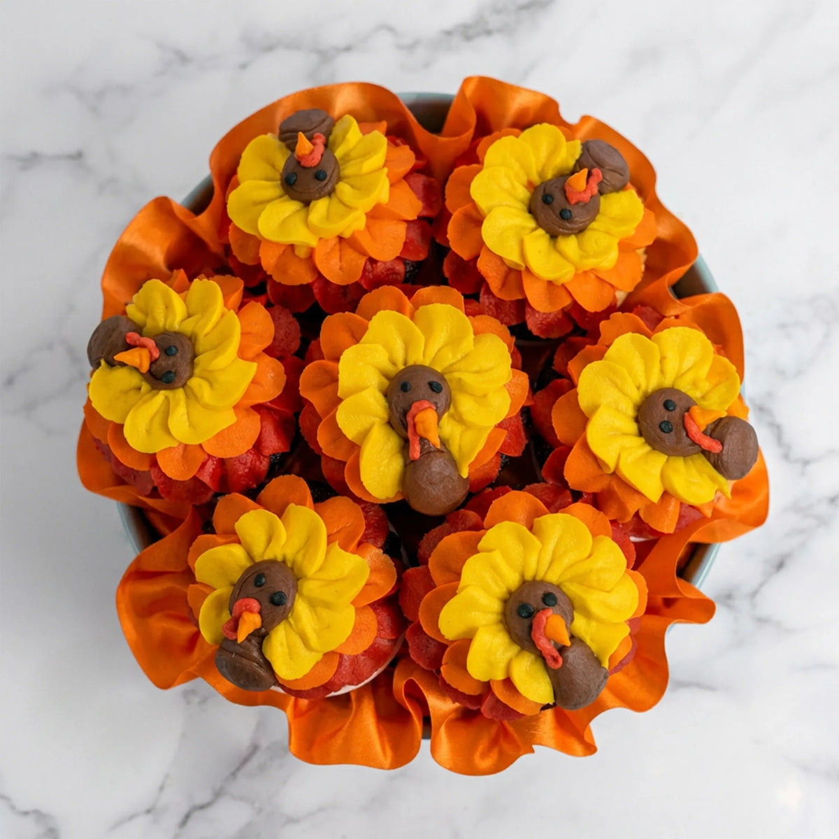Top view of a turkey cupcake bouquet with yellow, orange and red buttercream feathers and turkey faces, kosher, made in Chestnut Hill MA