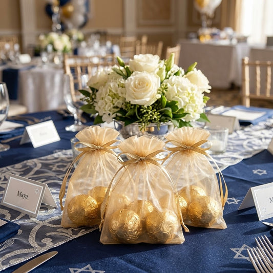 Champagne organza favor bags with gold foil Madelaine chocolates on a bat mitzvah guest table, kosher, made in Chestnut Hill MA