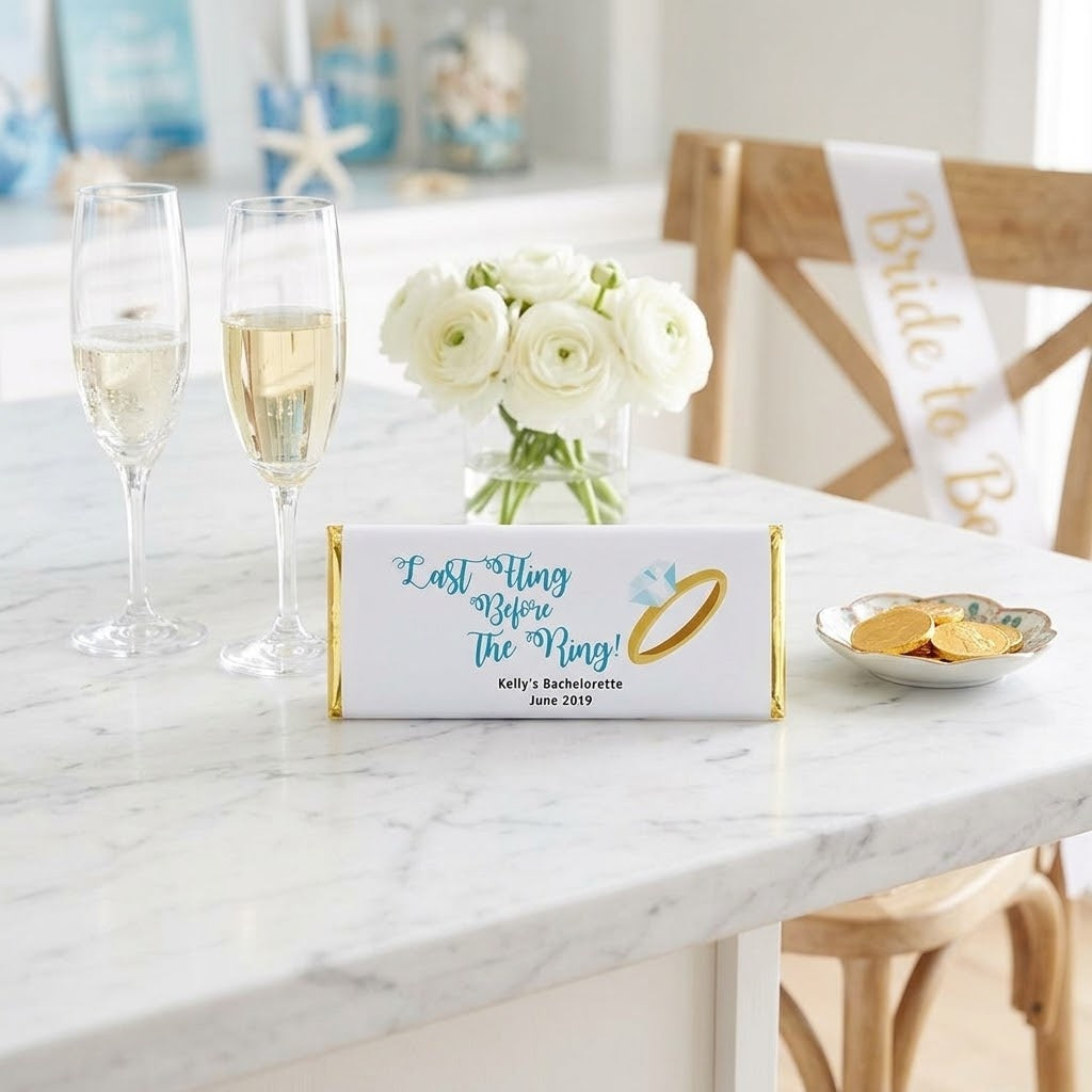 Ring design, personalized ring bachelorette wrapped Hershey bar styled on a coastal kitchen island with champagne and gold foil chocolate coins