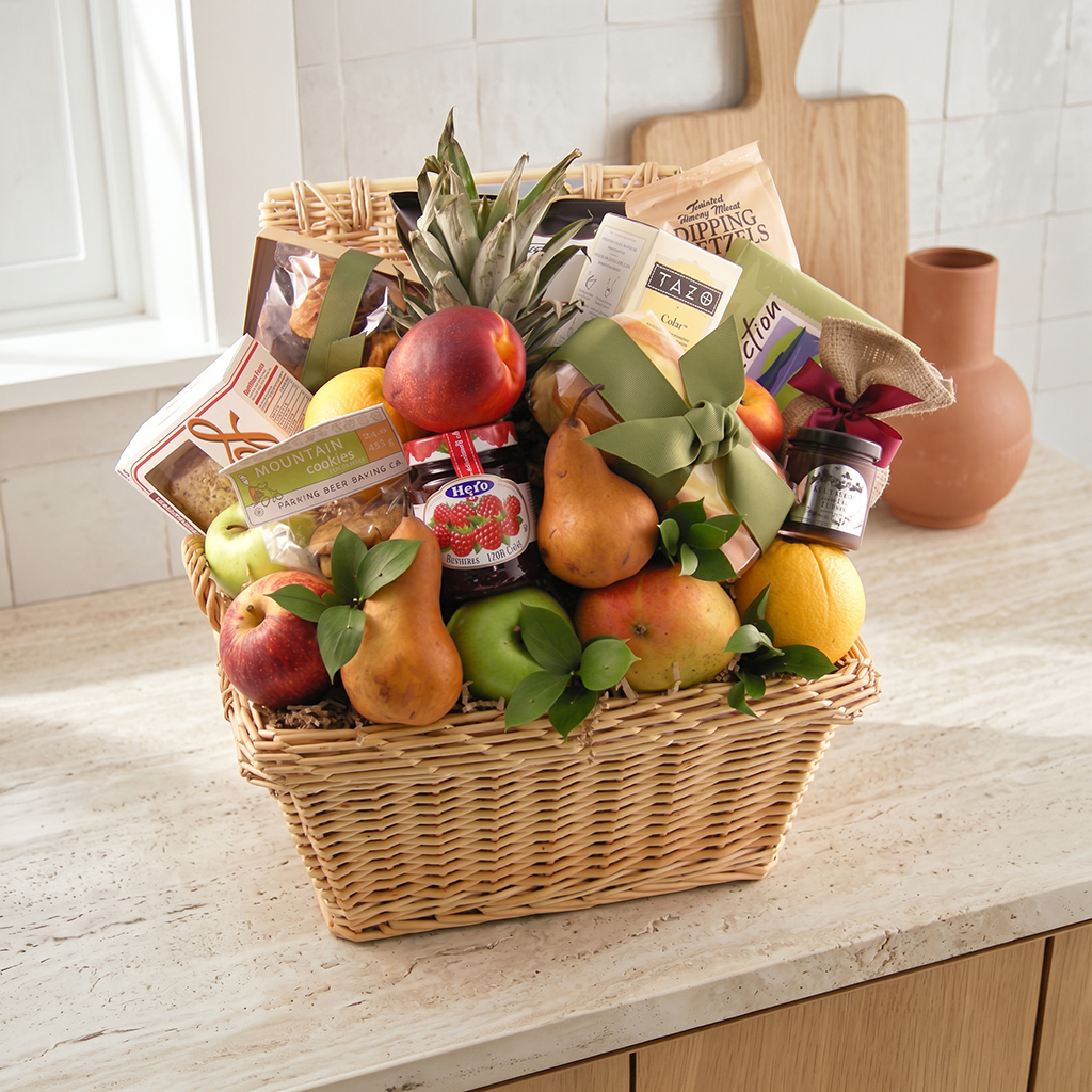 Large sympathy fruit basket with fresh seasonal fruit, chocolates, dried fruit, nuts, crackers, jam and cookies in a hamper basket