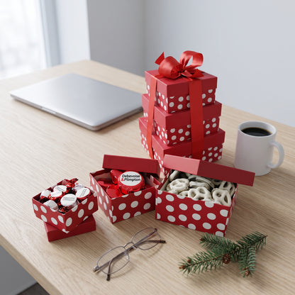 Small holiday gift tower of red polka dot boxes with logo candy, dipped Oreos and chocolate covered pretzels, styled on an office desk